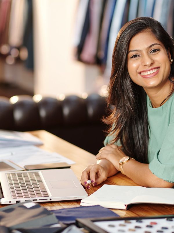 Happy young Indian atelier owner