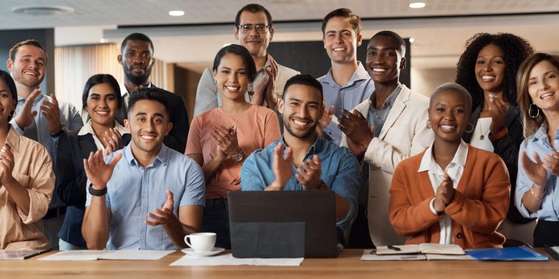 Shot of a group of young businesspeople clapping during a conference in a modern office.